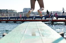 Child jumping off a springboard