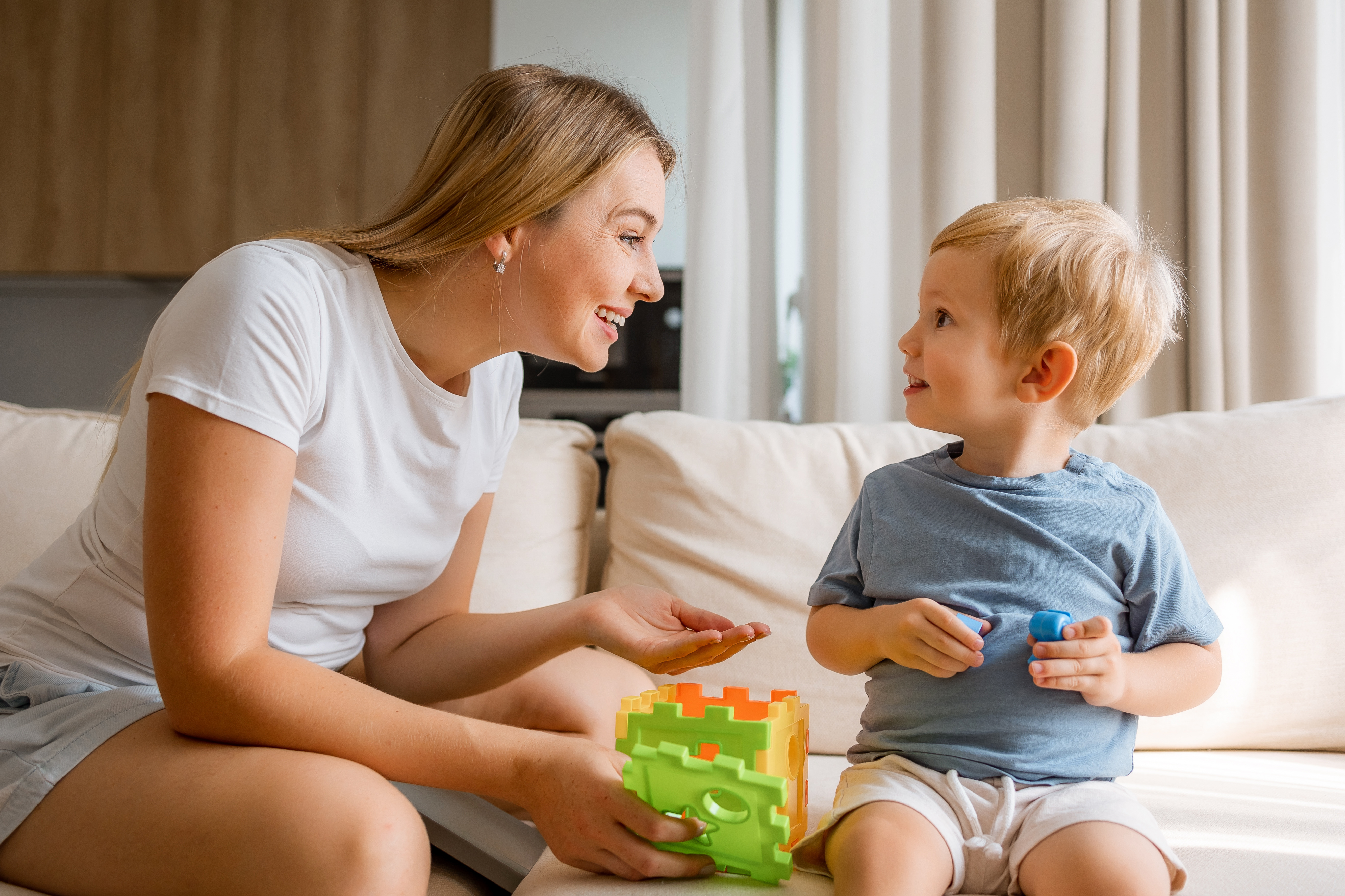 parent and young child playing with building blocks