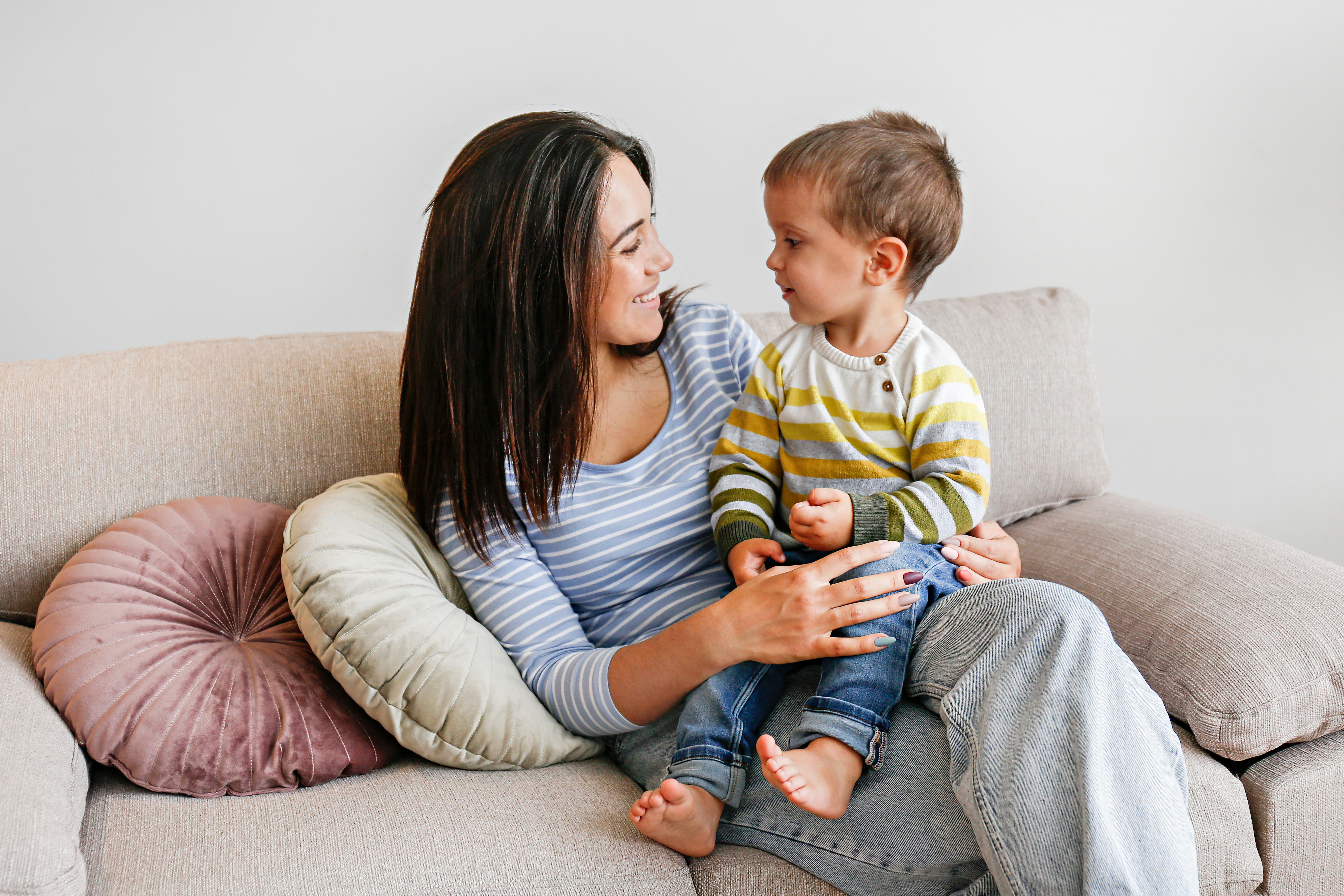 image of a parent and toddler on the couch talking together