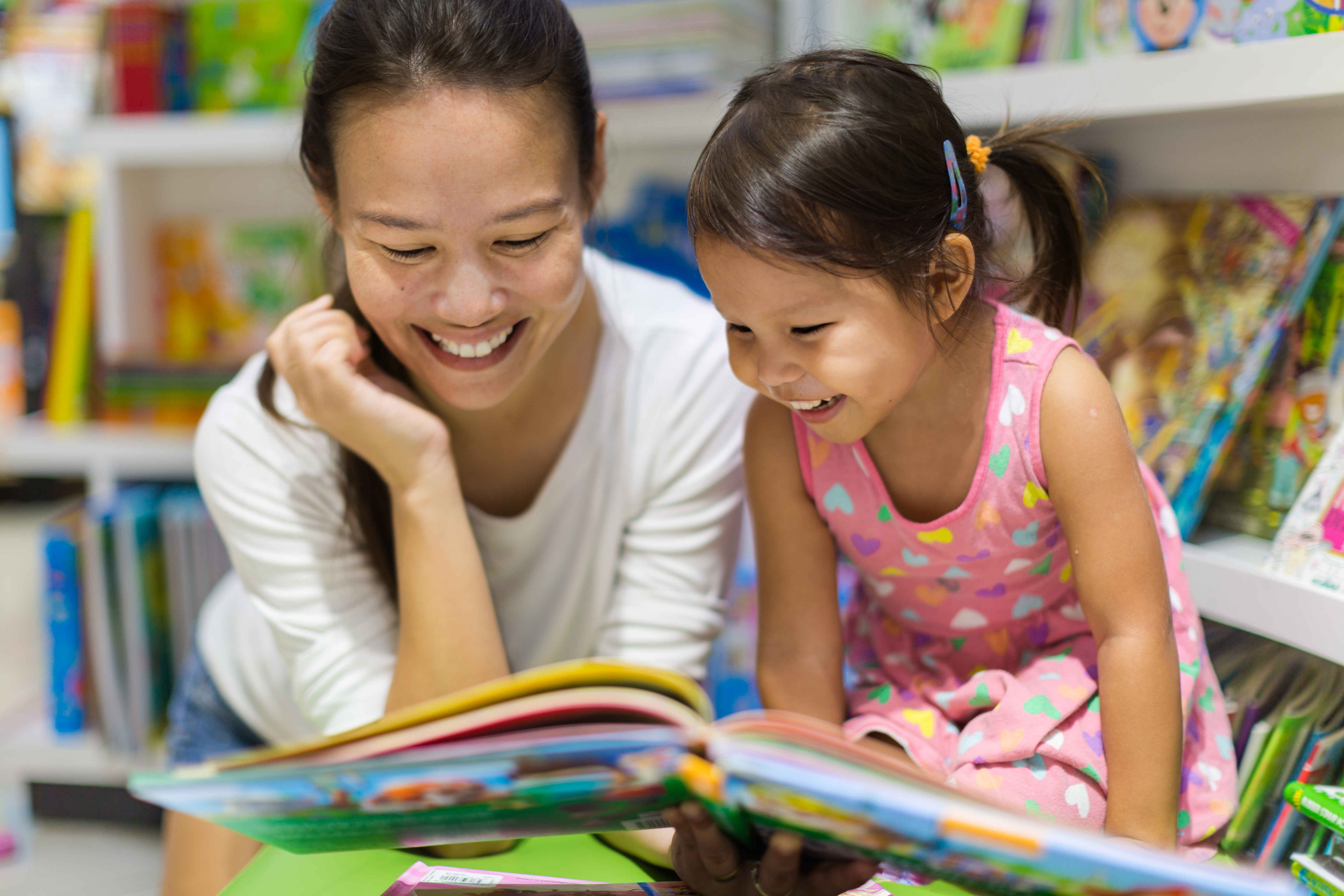 image of a child and an adult reading together and talking