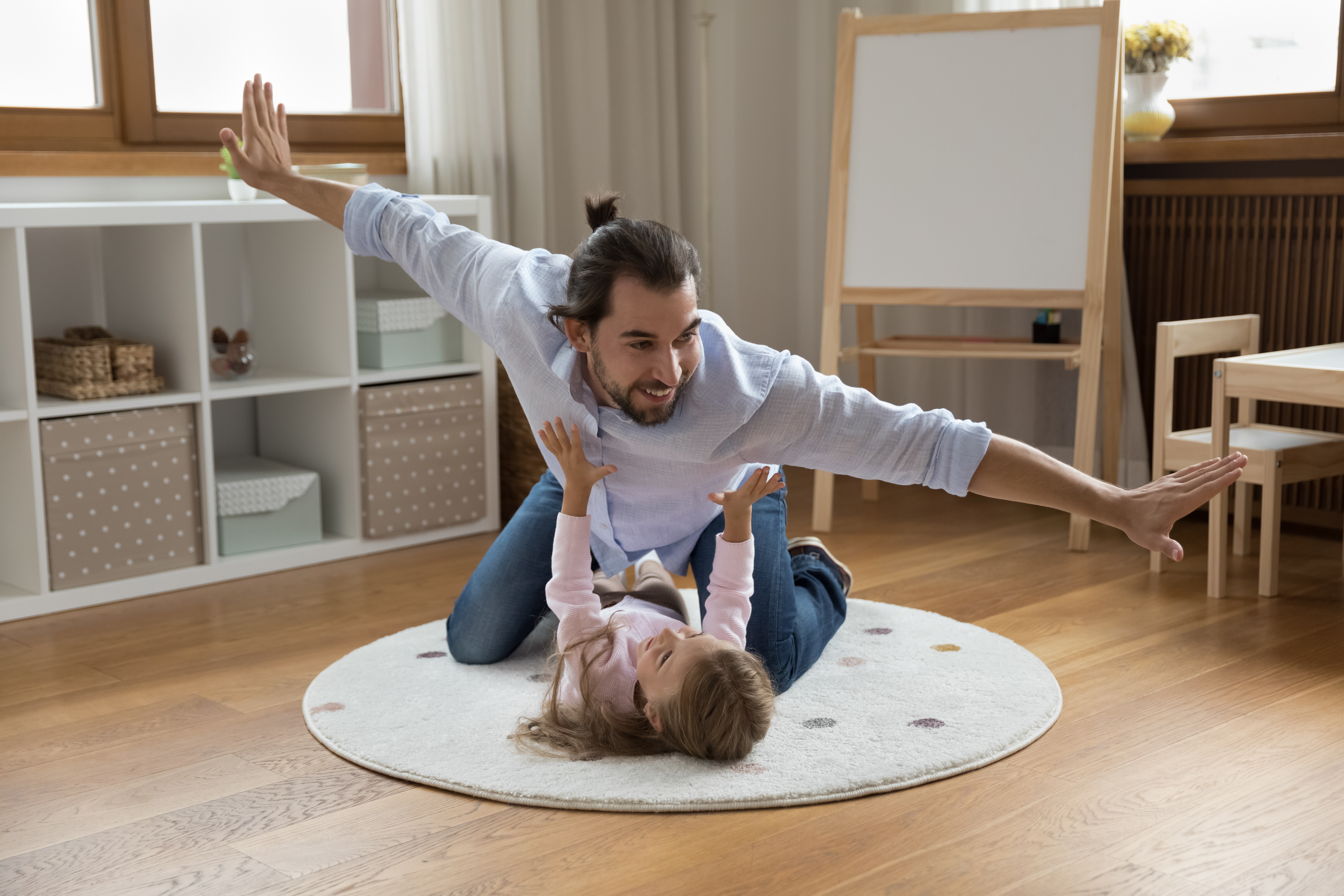 image of a parent and child playing airplane
