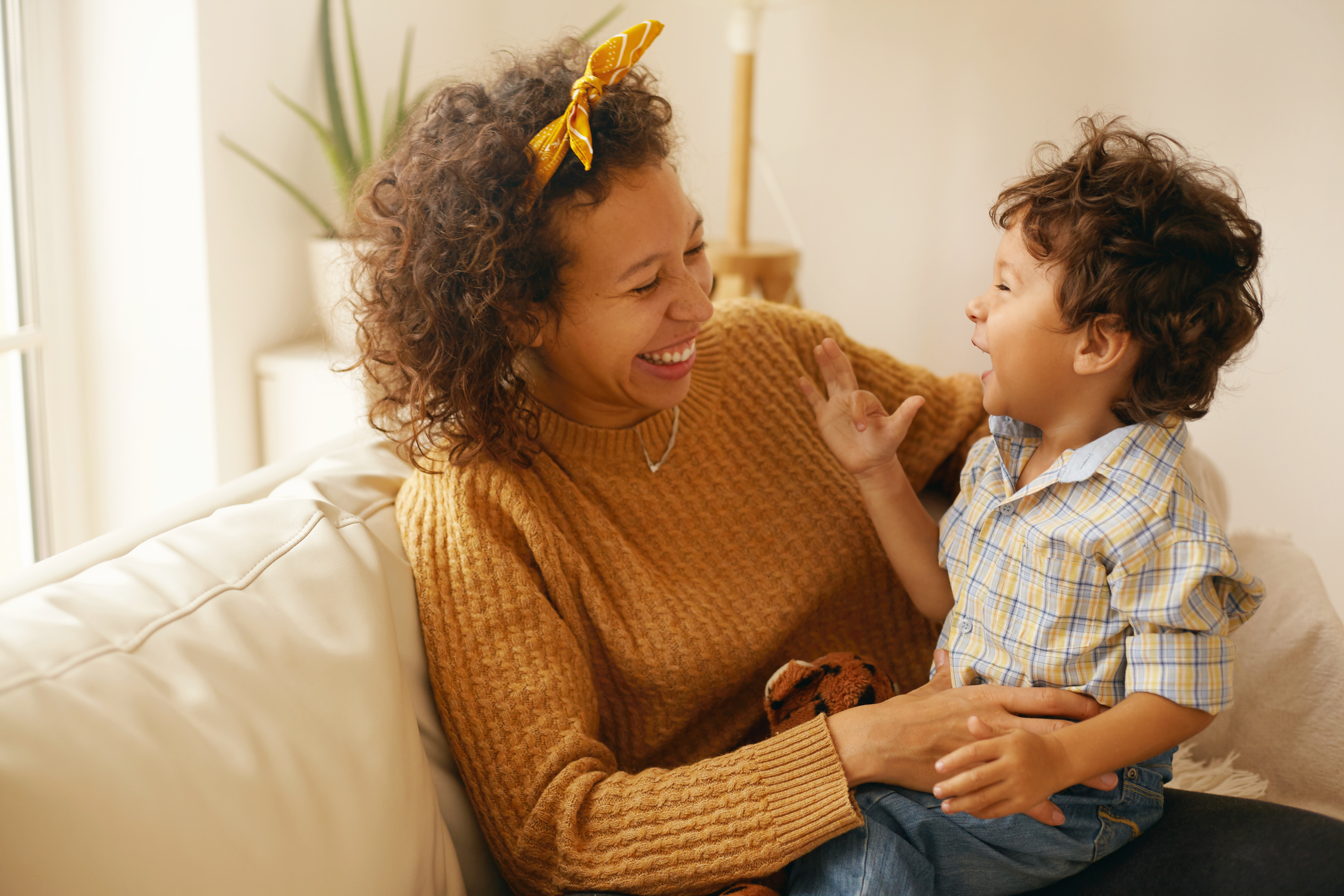 image of a parent and toddler talking and laughing